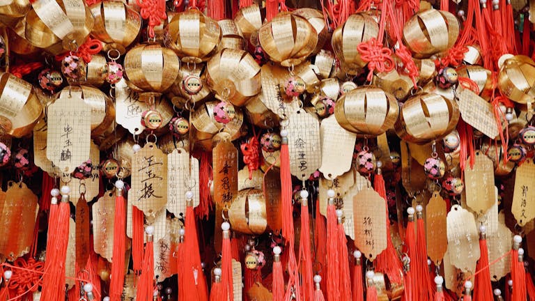 Close-up of golden temple ornaments and red tassels at Wong Tai Sin Temple in Kowloon, Hong Kong.